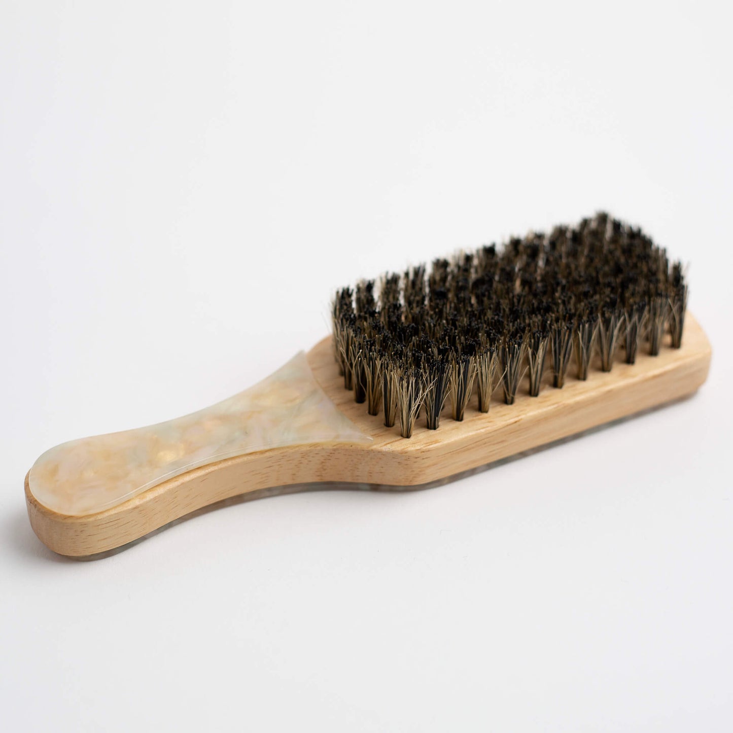 THOC Lulu Travel Brush Buttermilk colour with a coluorful handle, bar bristles up on a white background