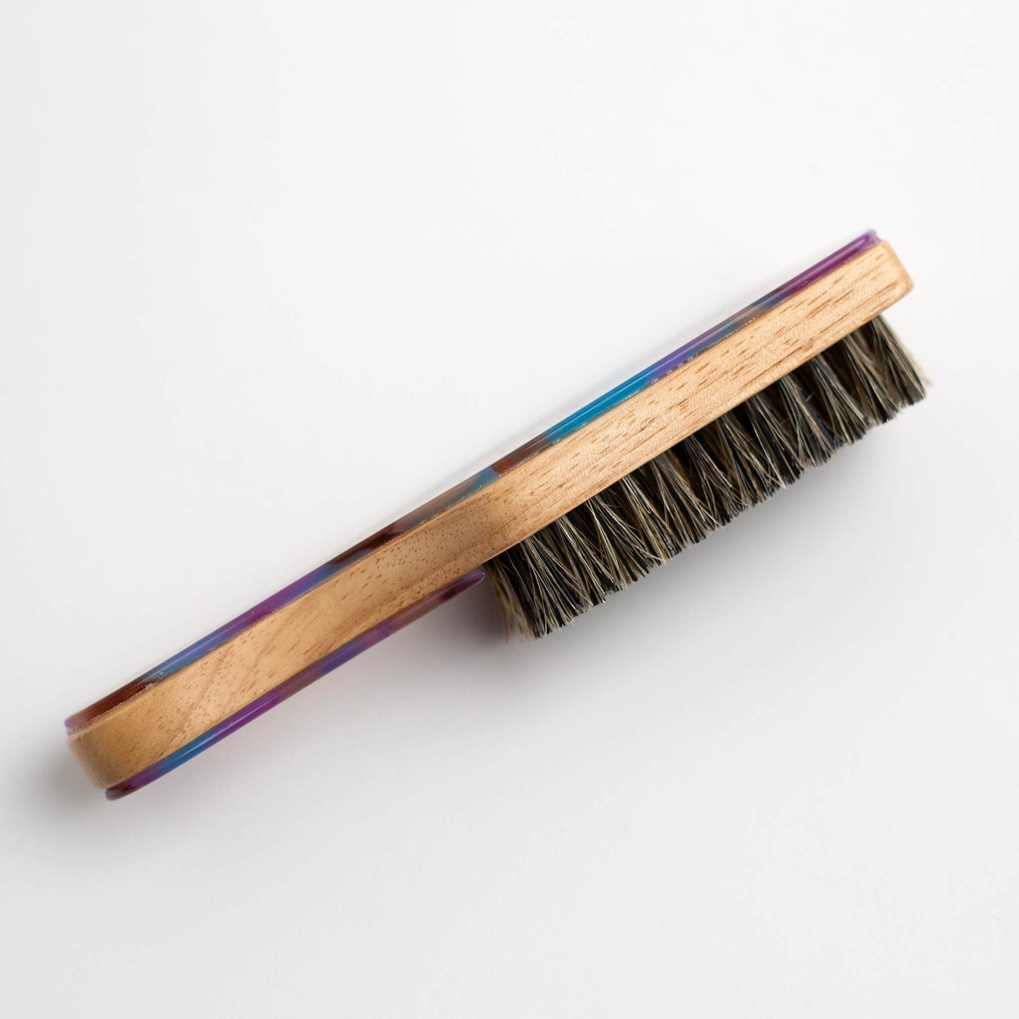 THOC Lulu Travel Brush Purple Pop on side on a white background, showing boar bristle head