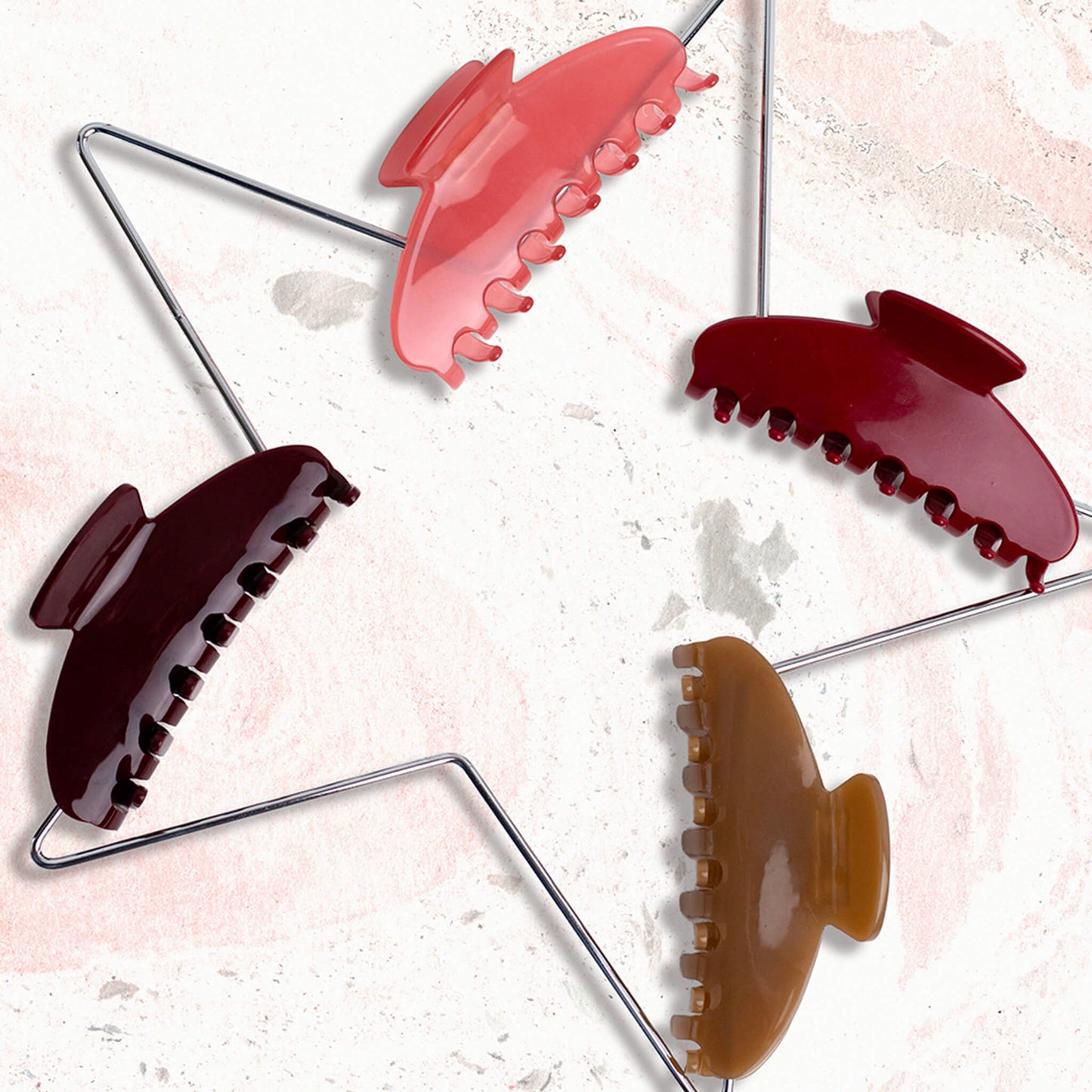 Set of colourful THOC claw clips on a white background with pink and grey marble effect