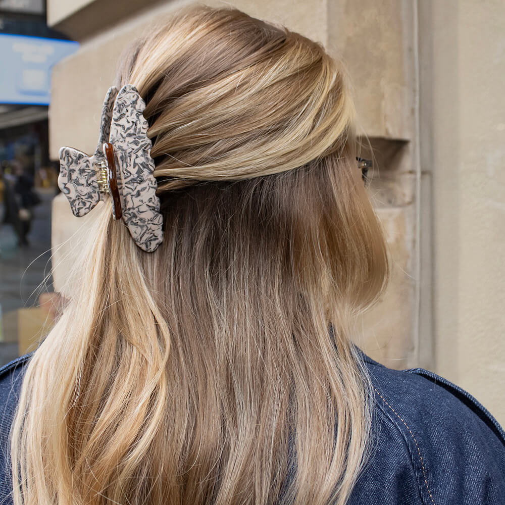 THOC Gigi Claw Clip in Toasted Bean on a model with blonde hair in a town setting