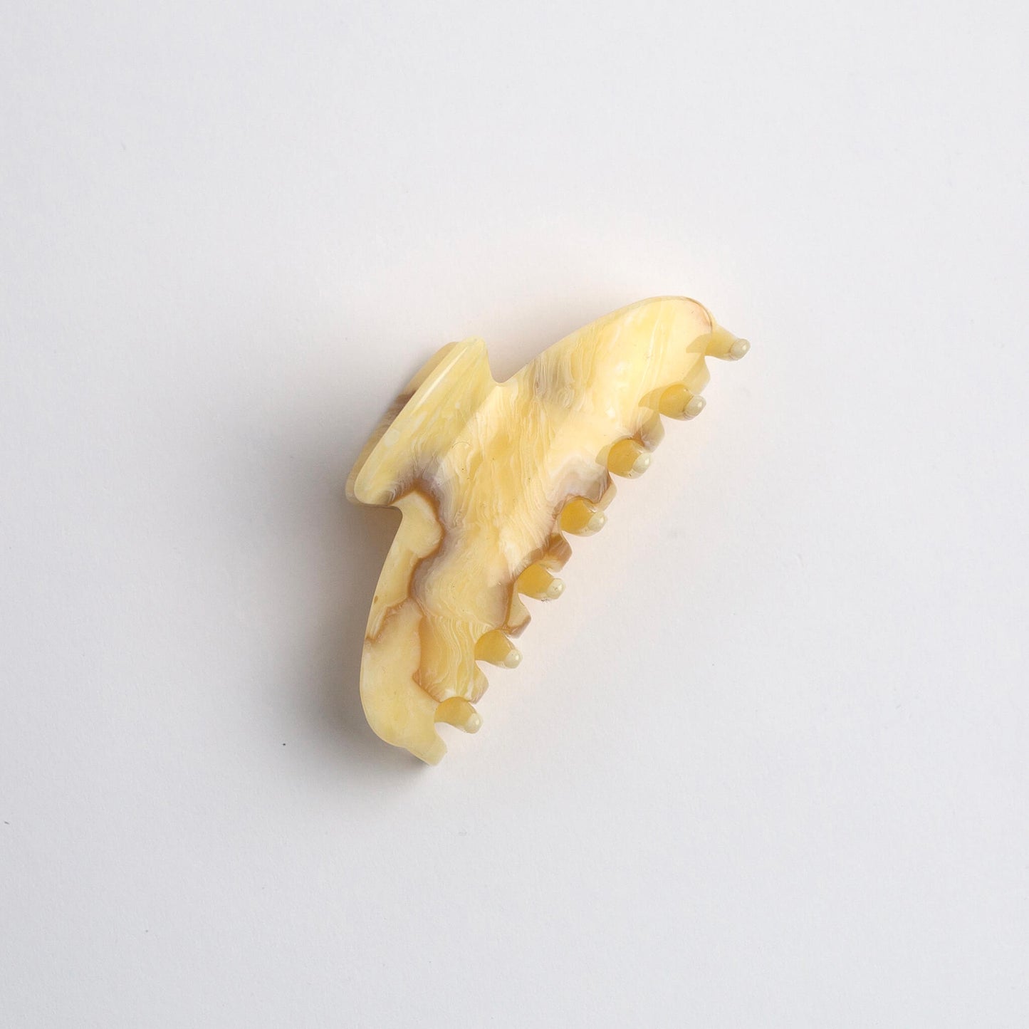 THOC Noa Claw Clip in Buttercream colour on its side on a white background