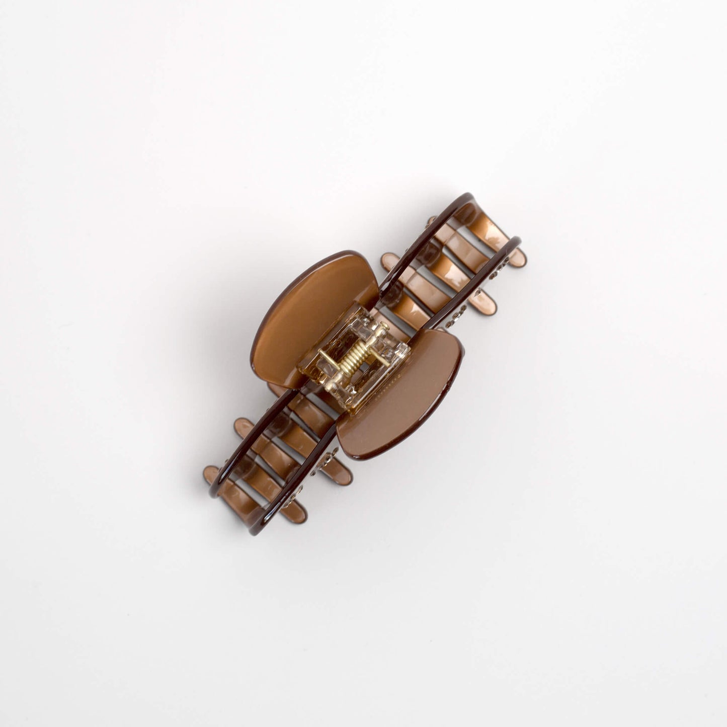 THOC Nori Claw Clip in golden brown with sparkly bejewelled flower pattern on side from the top angle 