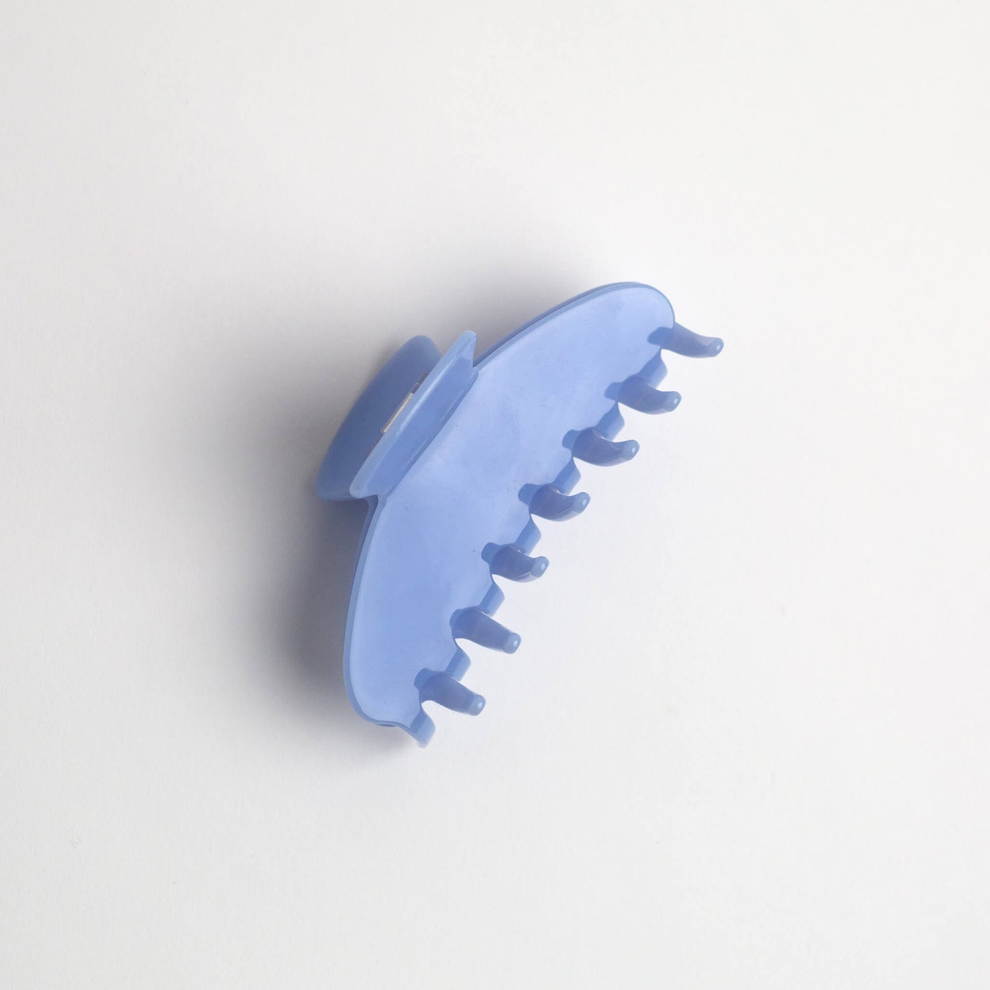 THOC Giselle Claw Clip in Candy Blue colour on its side on a white background
