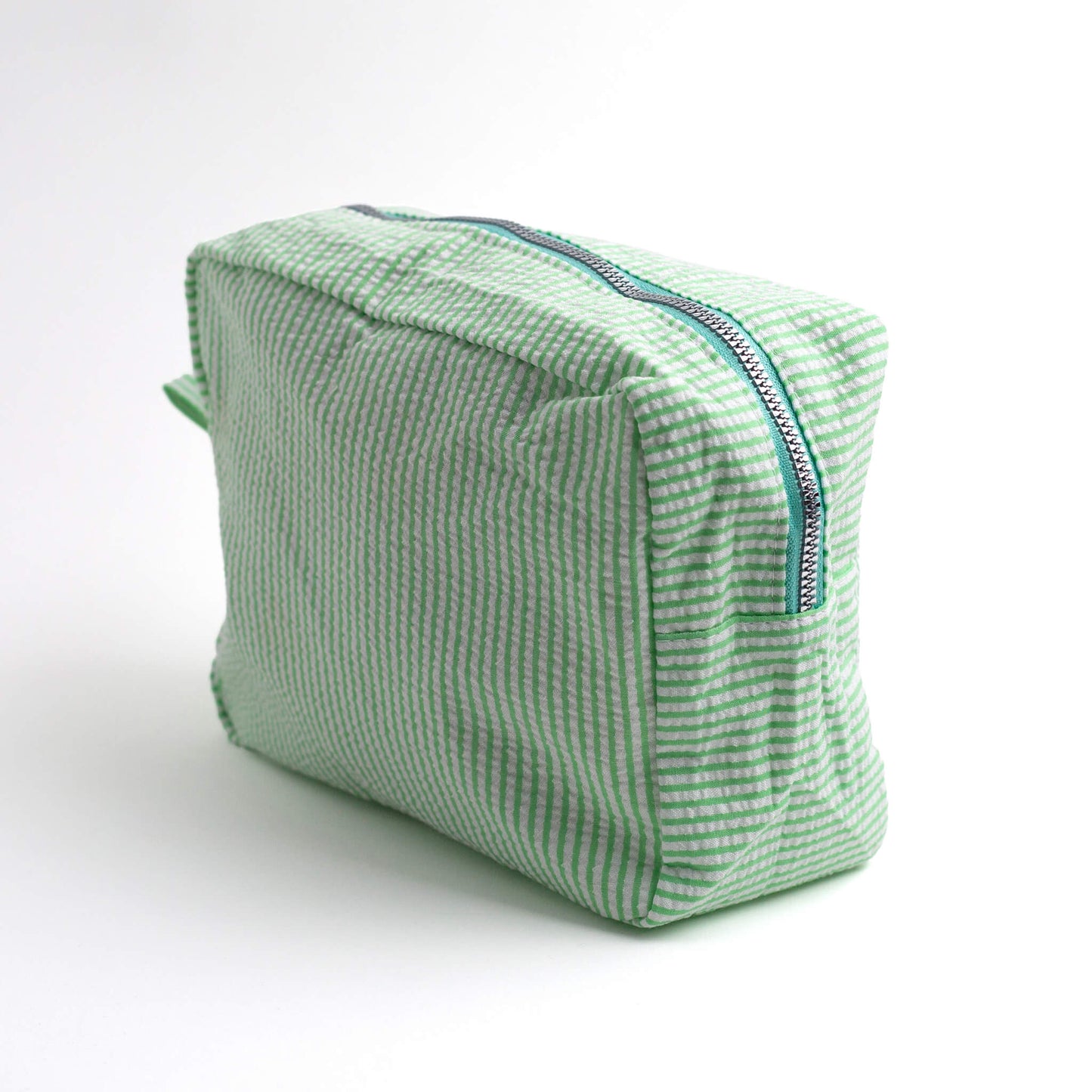 THOC Candy Beauty Bag Stripe green upright at an angle on a white background