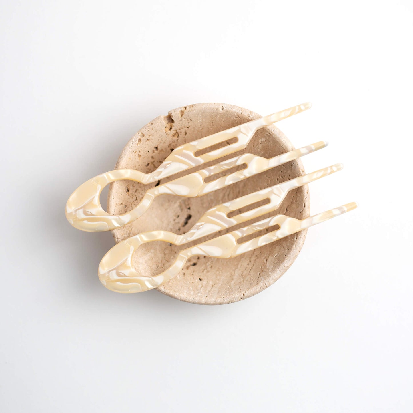 Two THOC Camille Hair Pin Vanilla Cream on a cream stone dish against a white background
