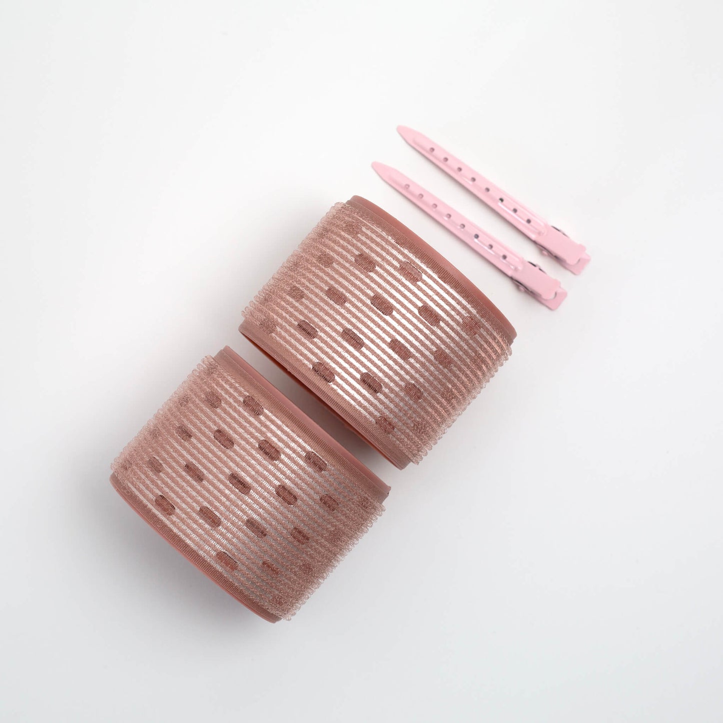 THOC Ceramic Thermal Hair Rollers Two large sized shown lying on their side with hair pins above