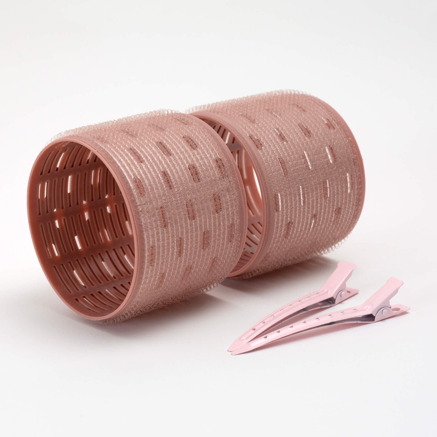 THOC Ceramic Thermal Hair Rollers Two large sized shown lying on their side with hair pins lying next to