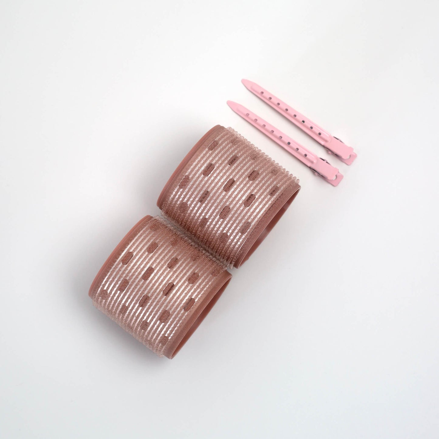 THOC Ceramic Thermal Hair Rollers Two medium sized shown lying on their side with hair pins above