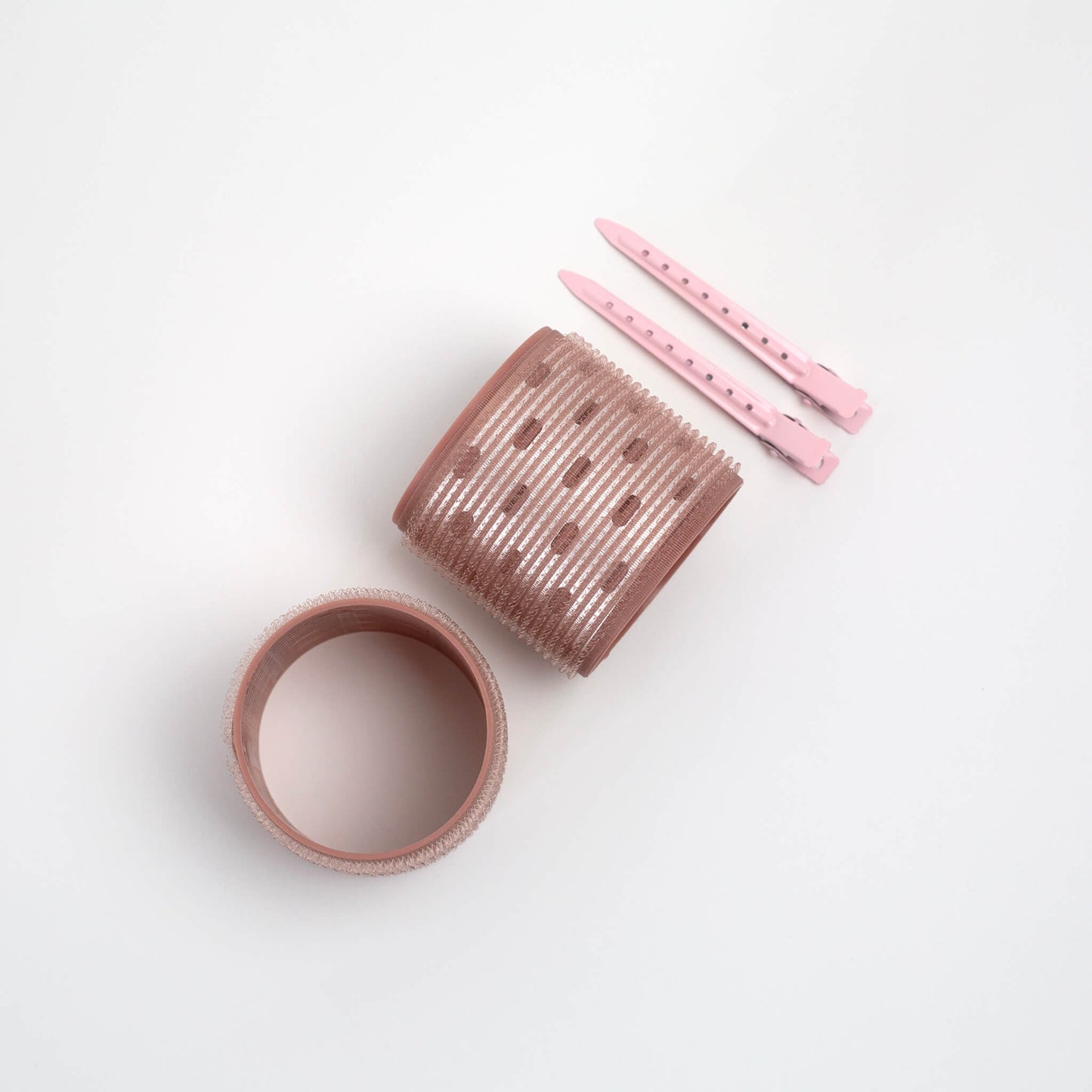 THOC  Ceramic Thermal Hair Rollers Two medium sized one shown upright and one shown lying down on side with hair pins