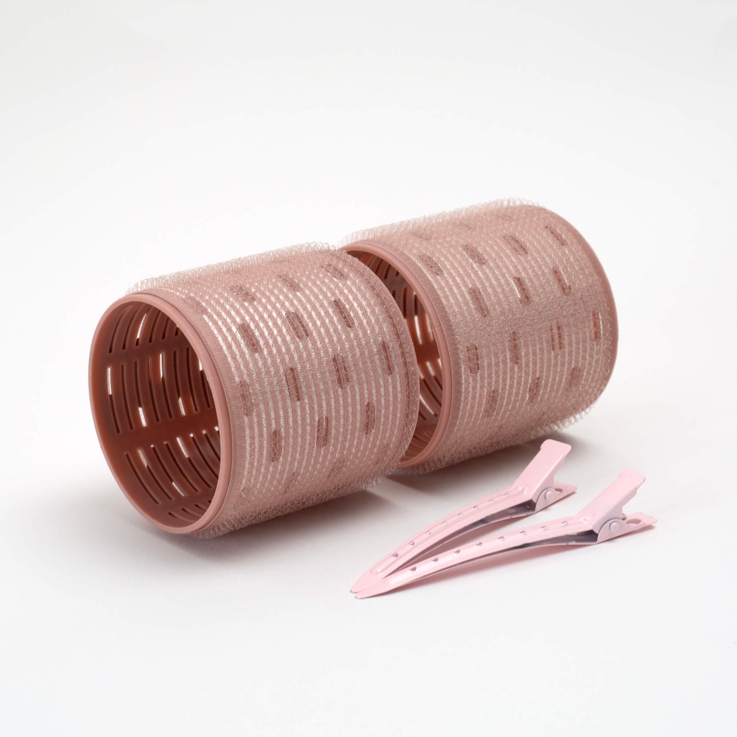 THOC  Ceramic Thermal Hair Rollers Two medium sized shown lying on their side with hair pins lying next to
