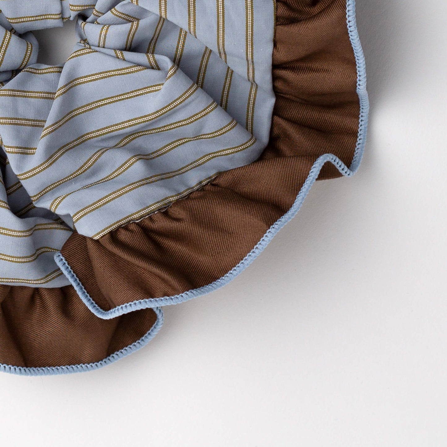 Close up of THOC Bloom Trimmed Scrunchie Blue Stripe on white background
