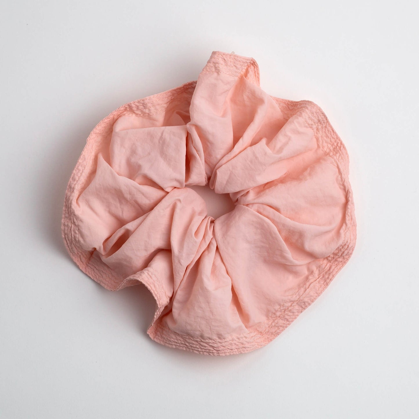 THOC Blush Scrunchie in Peach Melba colour shown on a white background